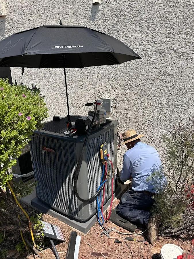 HVAC technician performing outdoor AC maintenance in West Ocean City